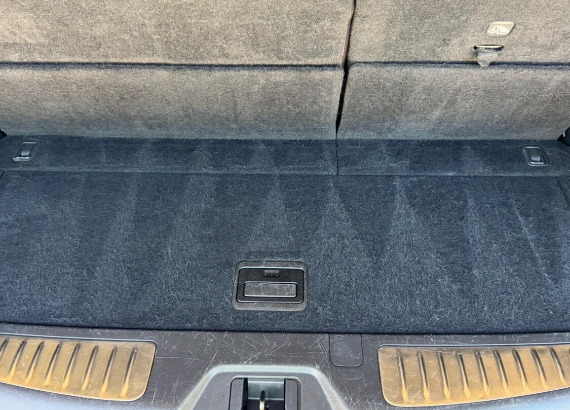Clean carpeted cargo area inside a detailed SUV