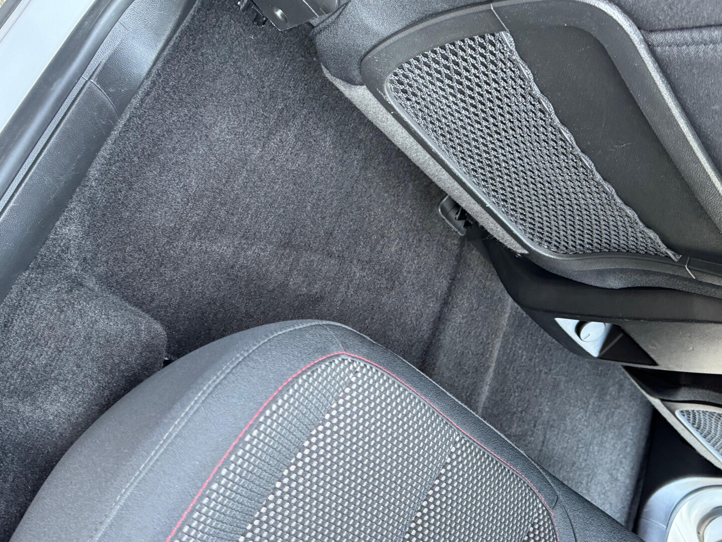 Clean carpet and seat area inside a detailed SUV